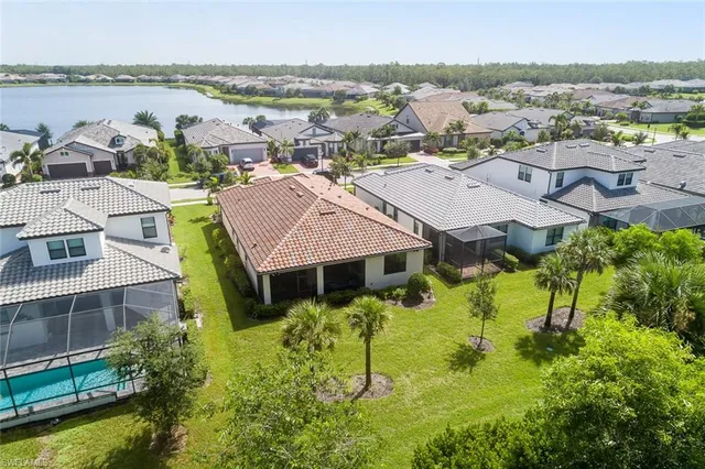 an aerial view of residential houses with outdoor space and swimming pool