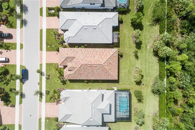 a aerial view of a house with swimming pool and ocean view