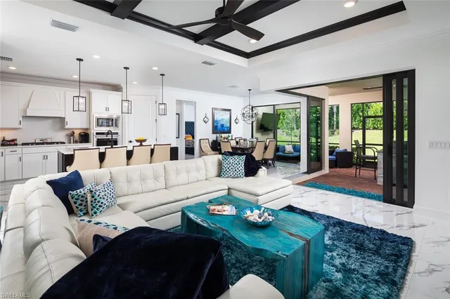 a living room with furniture fireplace and a large window