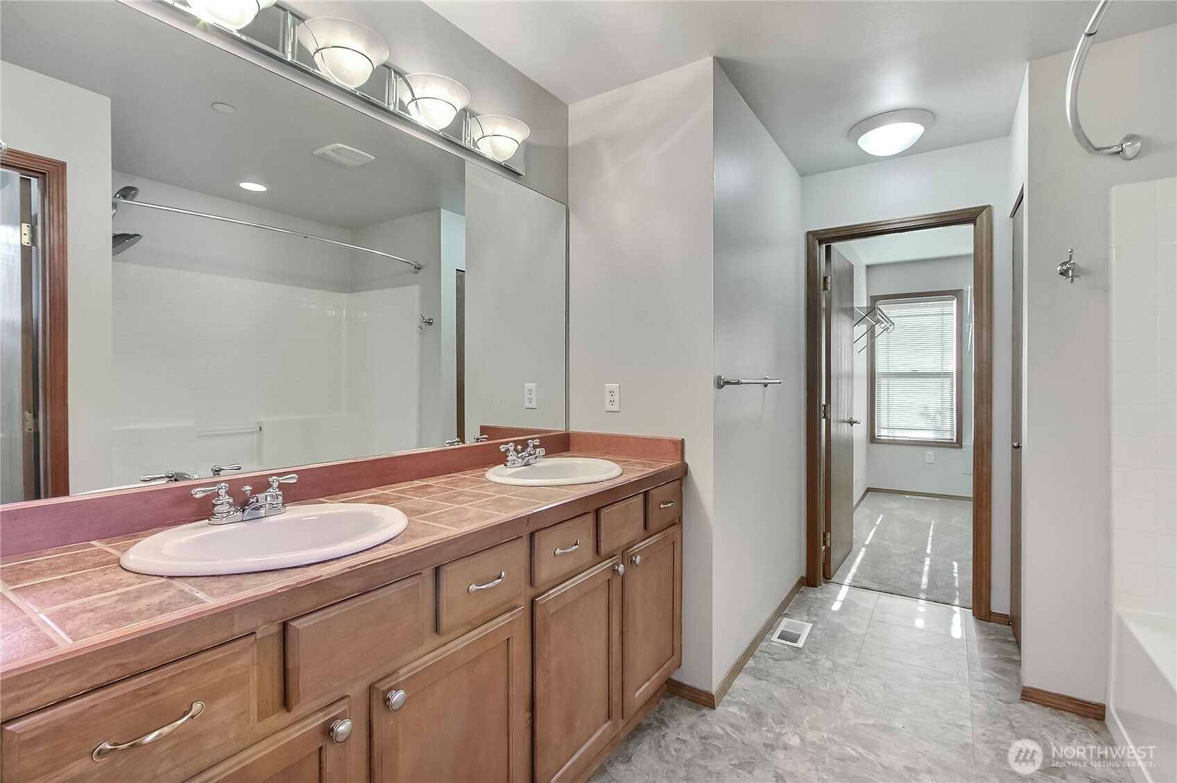 3157 Walker Road DuPont, WA 98327 - Photo 16 of 27 a bathroom with a granite countertop sink a large mirror and a shower