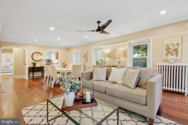 a living room with furniture kitchen view and a window