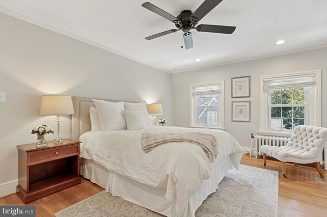 a spacious bedroom with a bed and a chandelier