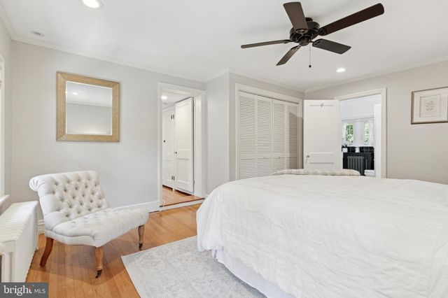 a spacious bedroom with a bed and a chandelier