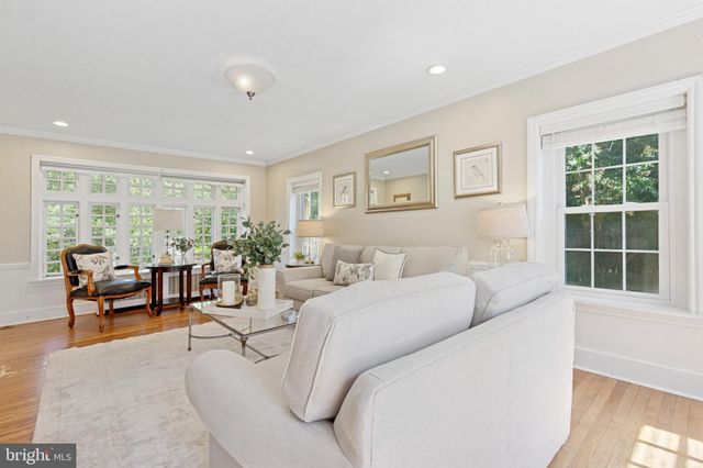 a living room with furniture and large windows