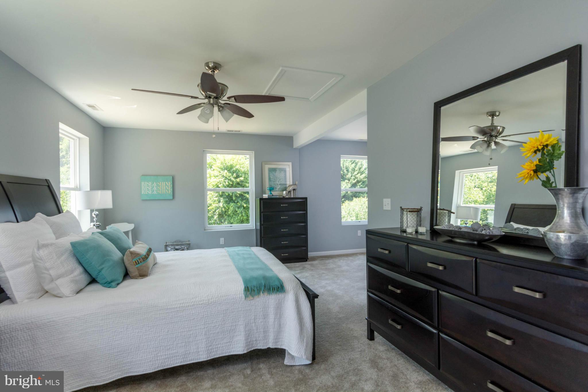 315 East Maple Road Linthicum Heights, MD 21090 - Photo 4 of 30 a bedroom with a bed and a chandelier