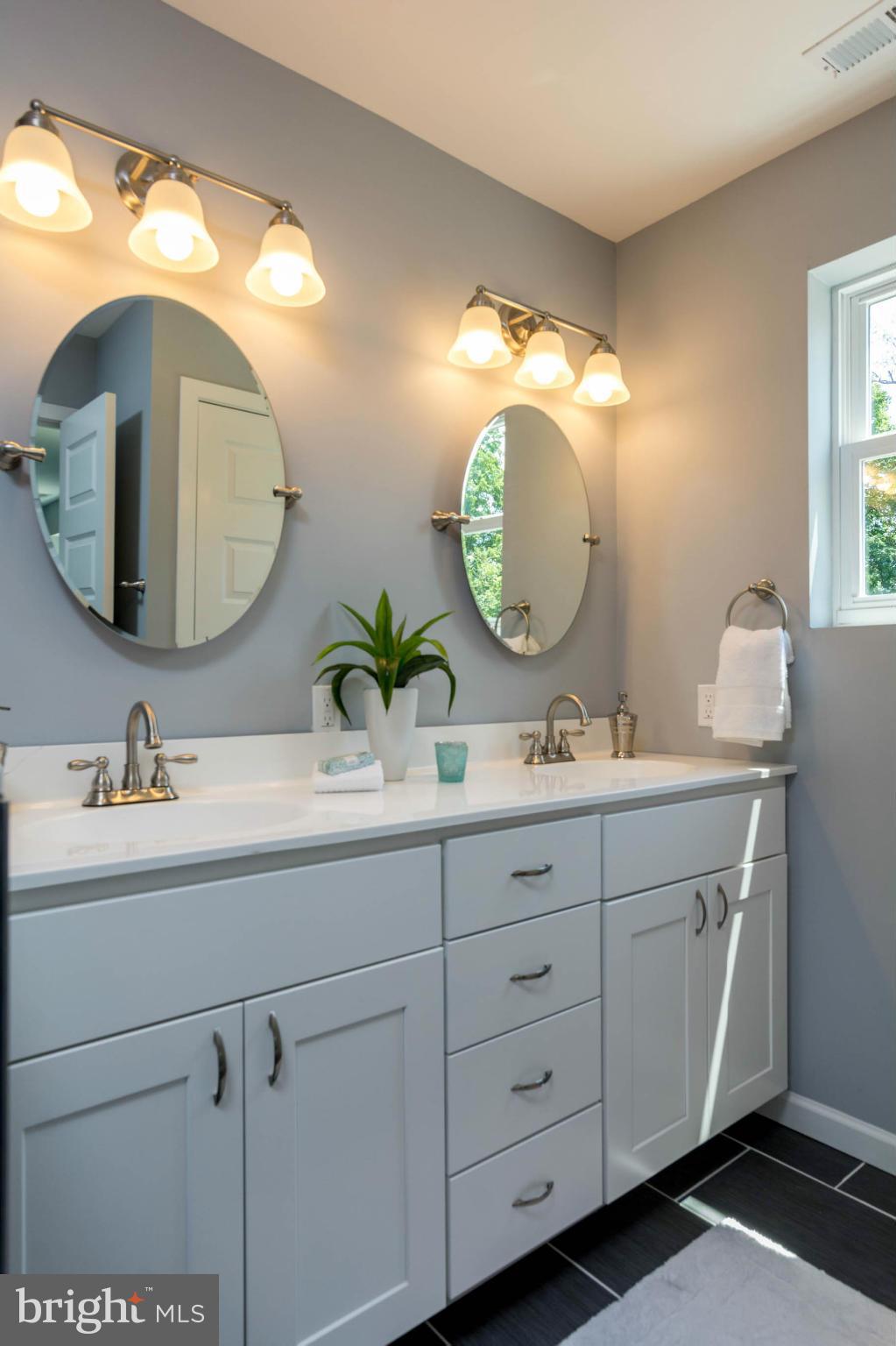315 East Maple Road Linthicum Heights, MD 21090 - Photo 7 of 30 a bathroom with a double vanity sink and a mirror