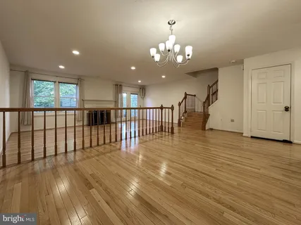 a view of a livingroom with floor to ceiling window and wooden floor