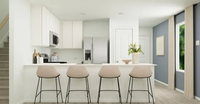 a kitchen with stainless steel appliances a stove a microwave and a refrigerator