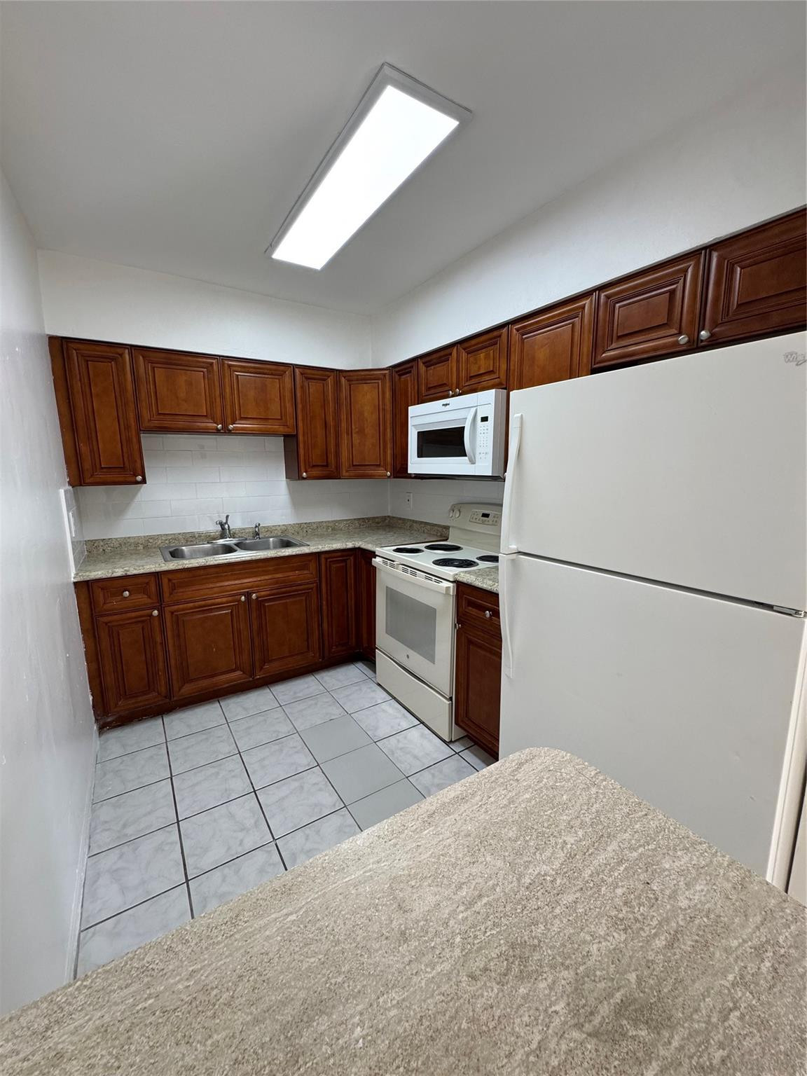 500 Nathan Hale Road, Unit 1 West Palm Beach, FL 33405 - Photo 2 of 8 a kitchen with stainless steel appliances granite countertop a refrigerator sink and cabinets