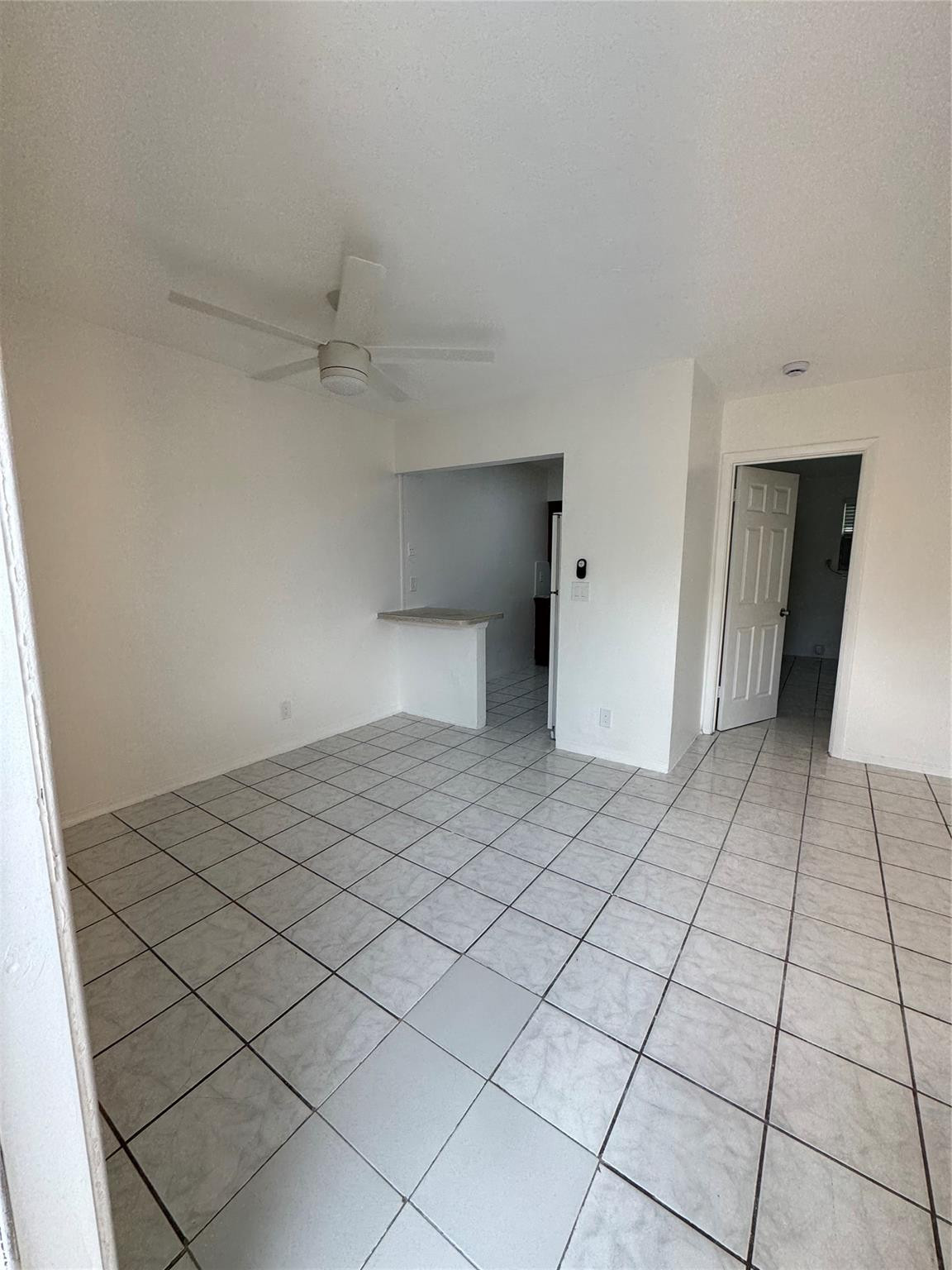 500 Nathan Hale Road, Unit 1 West Palm Beach, FL 33405 - Photo 3 of 8 a view of a room with a wooden floor and white walls