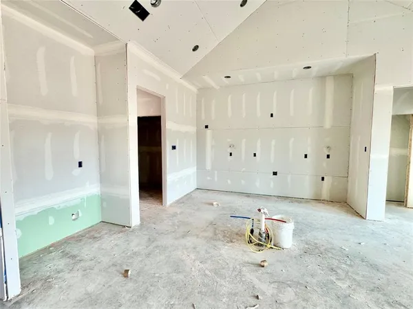 a view of an empty room with a fireplace and a window