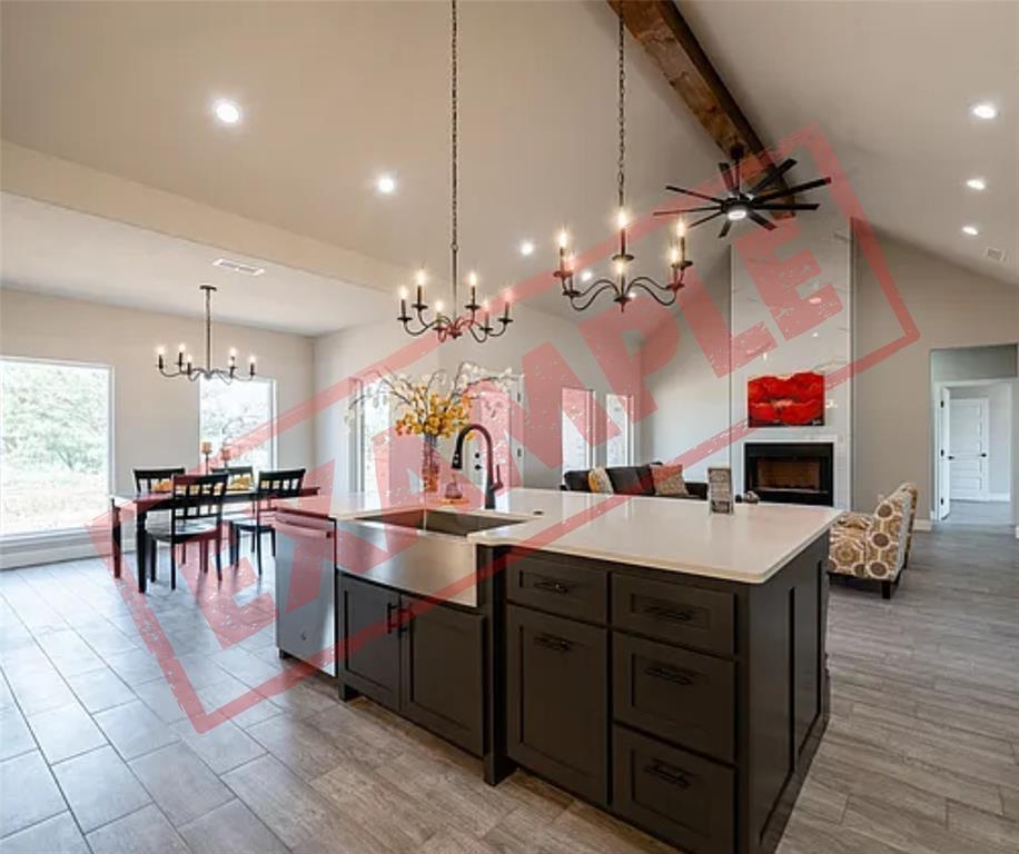 325 Wild Rye Road Abilene, TX 79606 - Photo 7 of 17 a room with kitchen island a sink and a chandelier