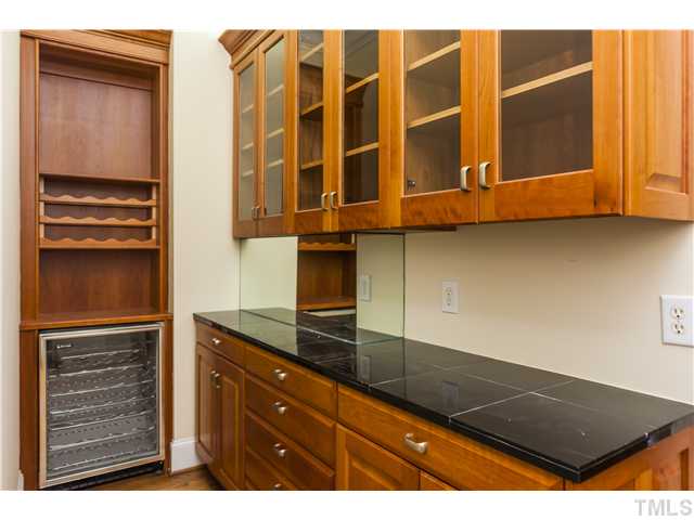 1913 Chase Court Raleigh, NC 27607 - Photo 22 of 25 Butler's pantry has more cherry cabinets for storage, a wine 'fridge, and built-in wine racks.
