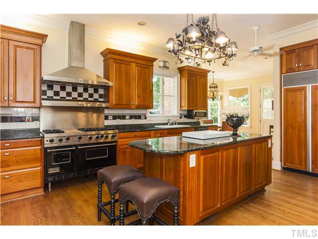 1913 Chase Court Raleigh, NC 27607 - Photo 5 of 25 Chef's kitchen has stone counters, custom cherry cabinets, Sub-Zero 'fridge, and a Viking commercial-type gas range.