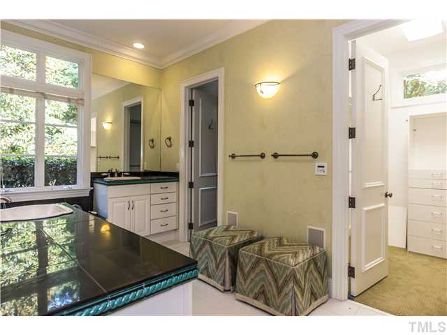 1913 Chase Court Raleigh, NC 27607 - Photo 10 of 25 Another view of the master bath, showing one of the master closets with built-ins and a transom window for natural light.
