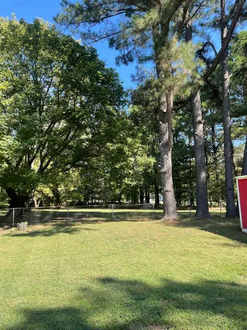 a view of swimming pool with trees in the background