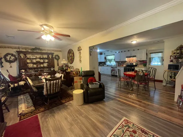 a living room with lots of furniture and kitchen view