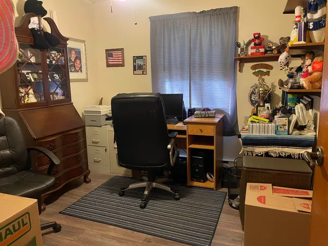 a work room with furniture and wooden floor