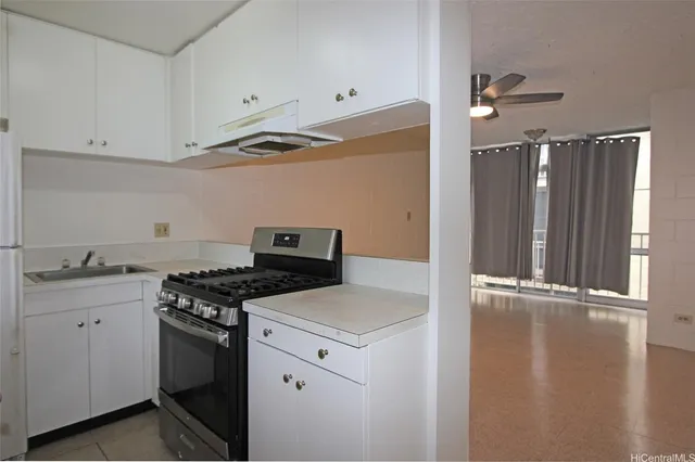 a kitchen with granite countertop a stove and a refrigerator