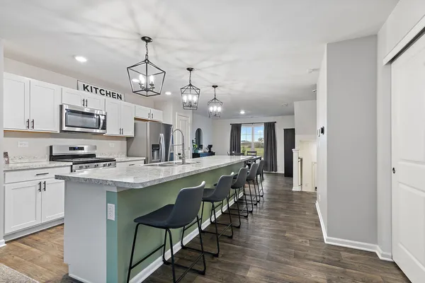 a large kitchen with a table and chairs in it
