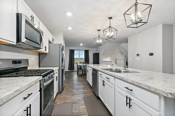 a large kitchen with stainless steel appliances granite countertop a lot of counter space