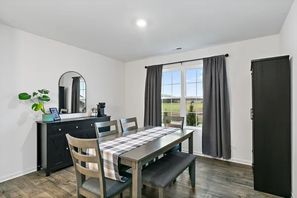 a view of a dining room with furniture window and wooden floor