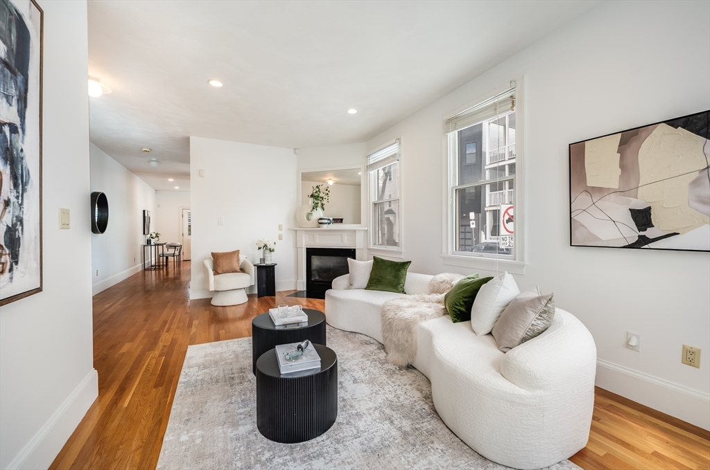 1520 Columbia Road, Unit 2 Boston, MA 02127 - Photo 2 of 16 a living room with fireplace furniture and a wooden floor