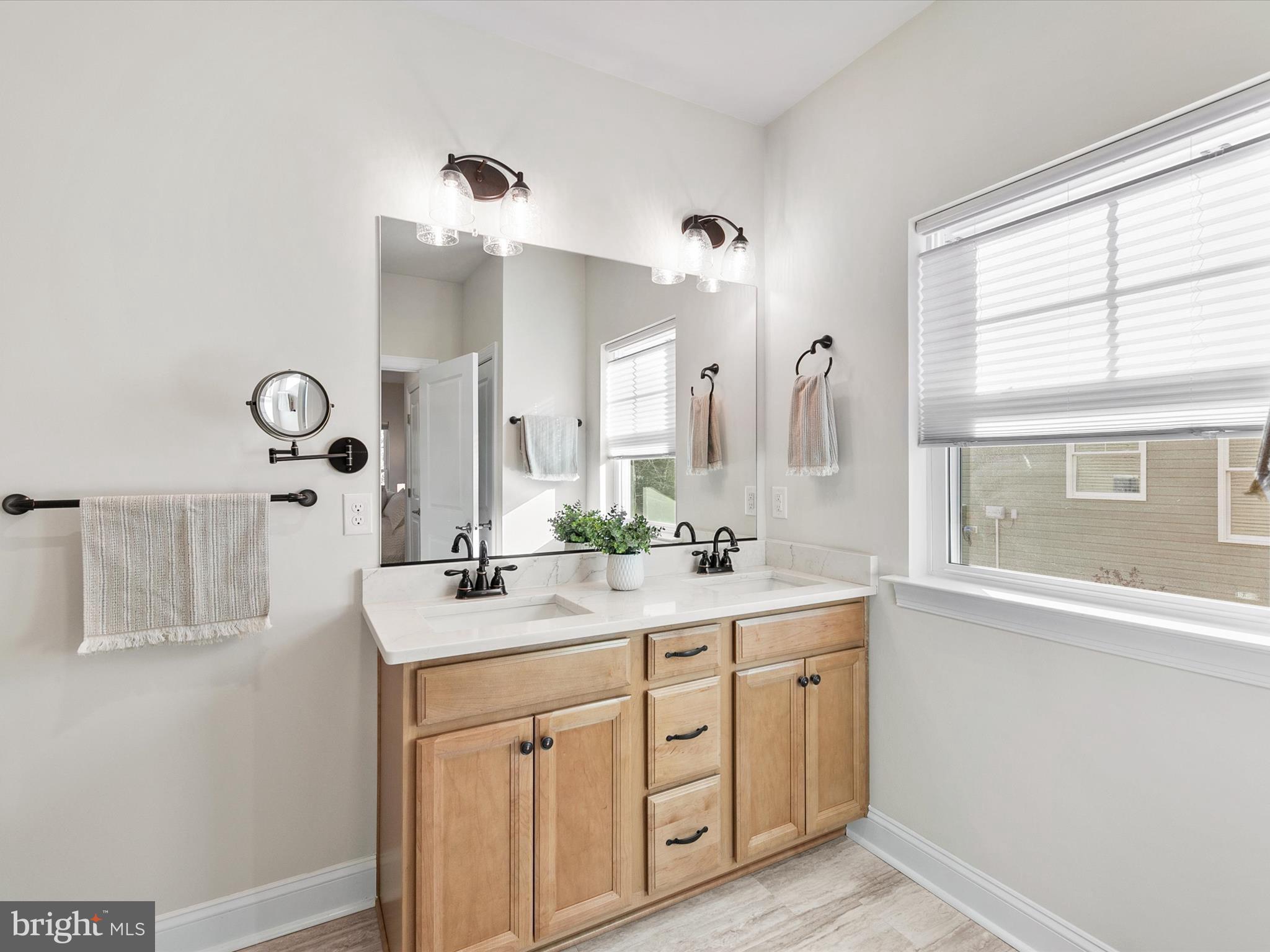 22657 Deep Woods Road Milton, DE 19968 - Photo 21 of 51 a bathroom with a double vanity sink and mirror