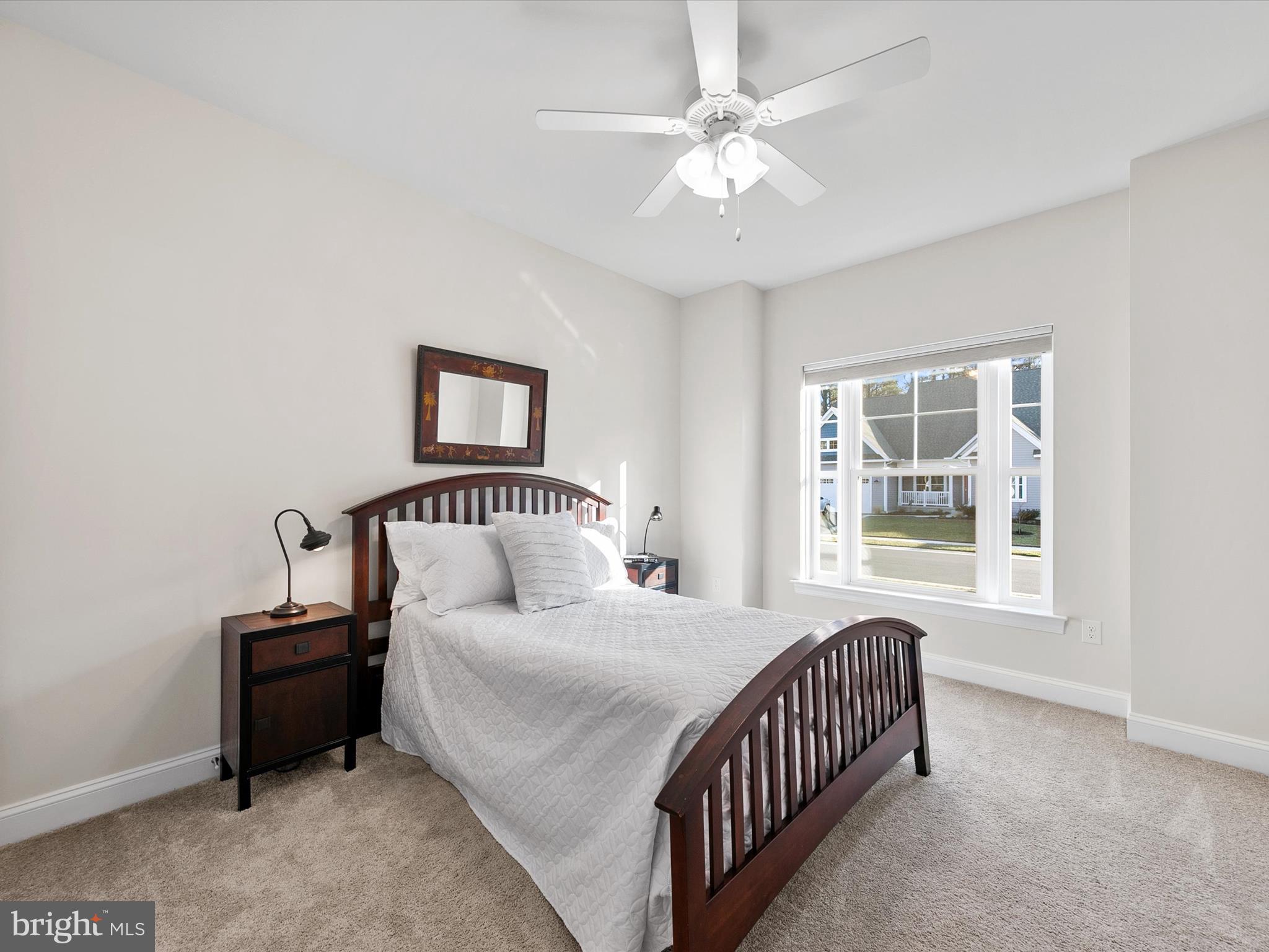 22657 Deep Woods Road Milton, DE 19968 - Photo 23 of 51 a bedroom with a large bed and a chandelier