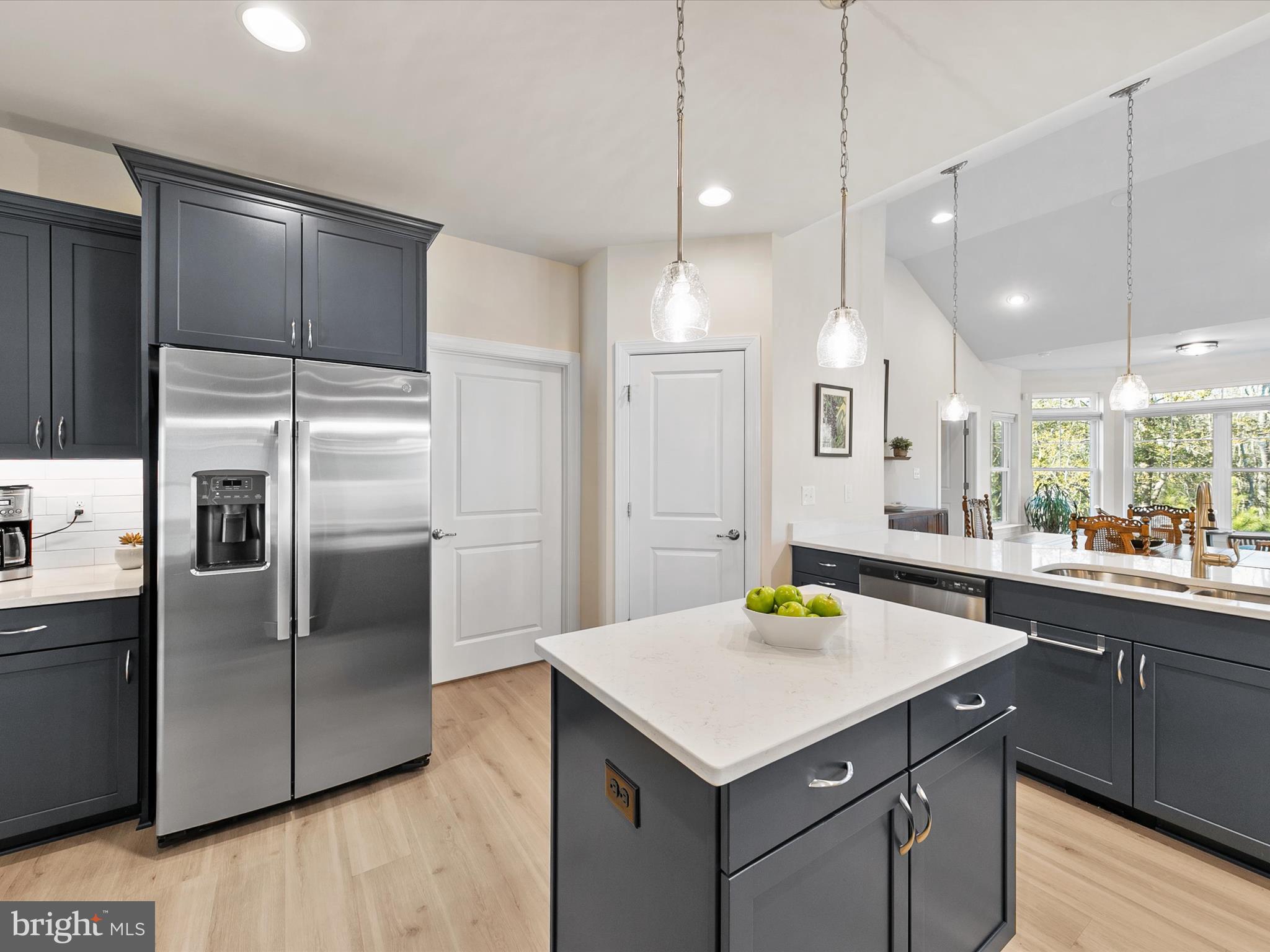 22657 Deep Woods Road Milton, DE 19968 - Photo 7 of 51 a kitchen with a sink a counter top space stainless steel appliances and wooden floor