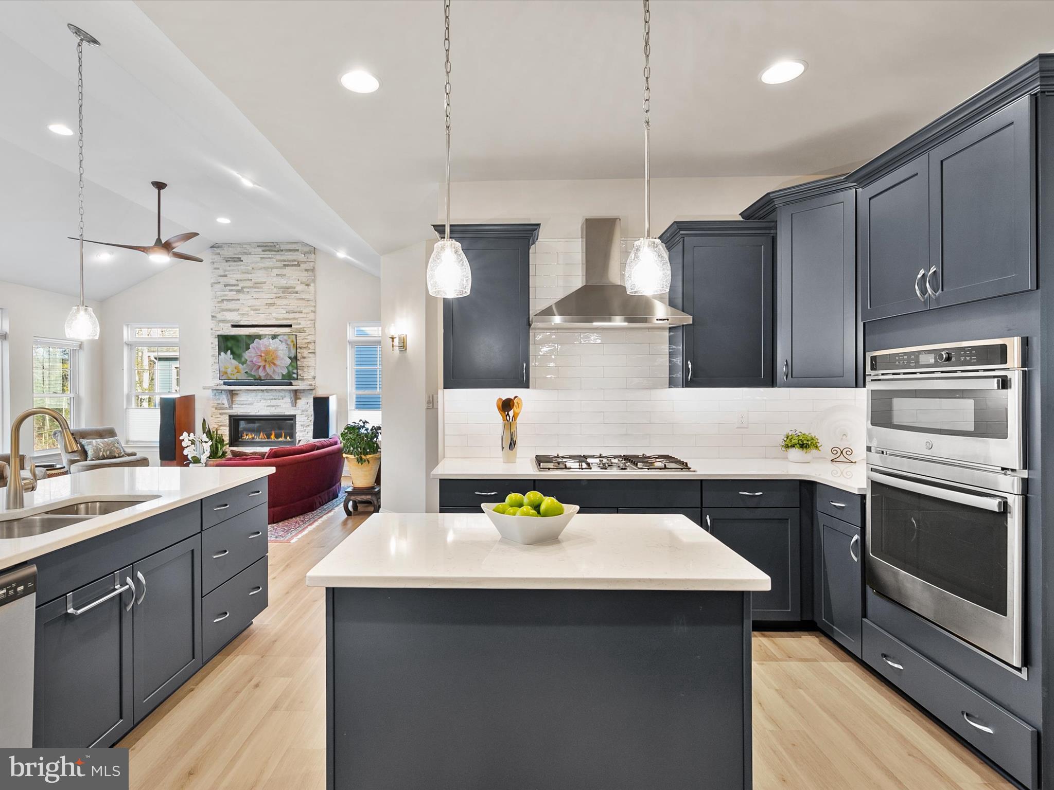 22657 Deep Woods Road Milton, DE 19968 - Photo 8 of 51 a kitchen with a sink a stove and chairs
