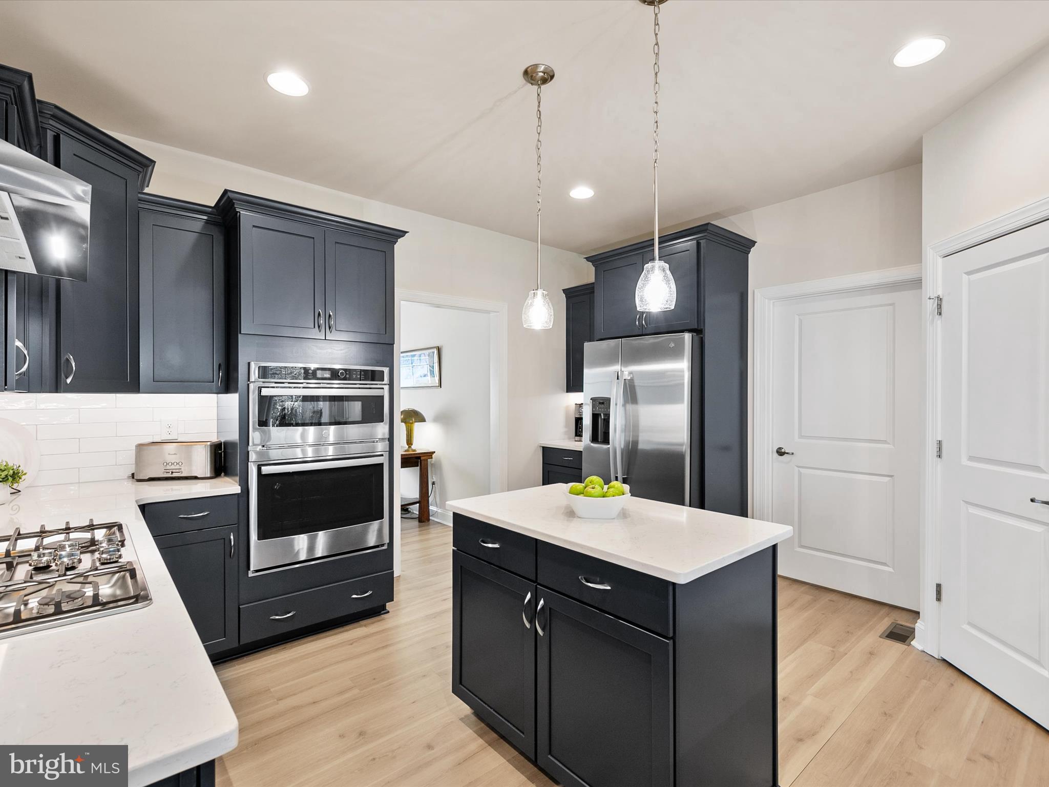 22657 Deep Woods Road Milton, DE 19968 - Photo 9 of 51 a kitchen with a sink refrigerator and microwave