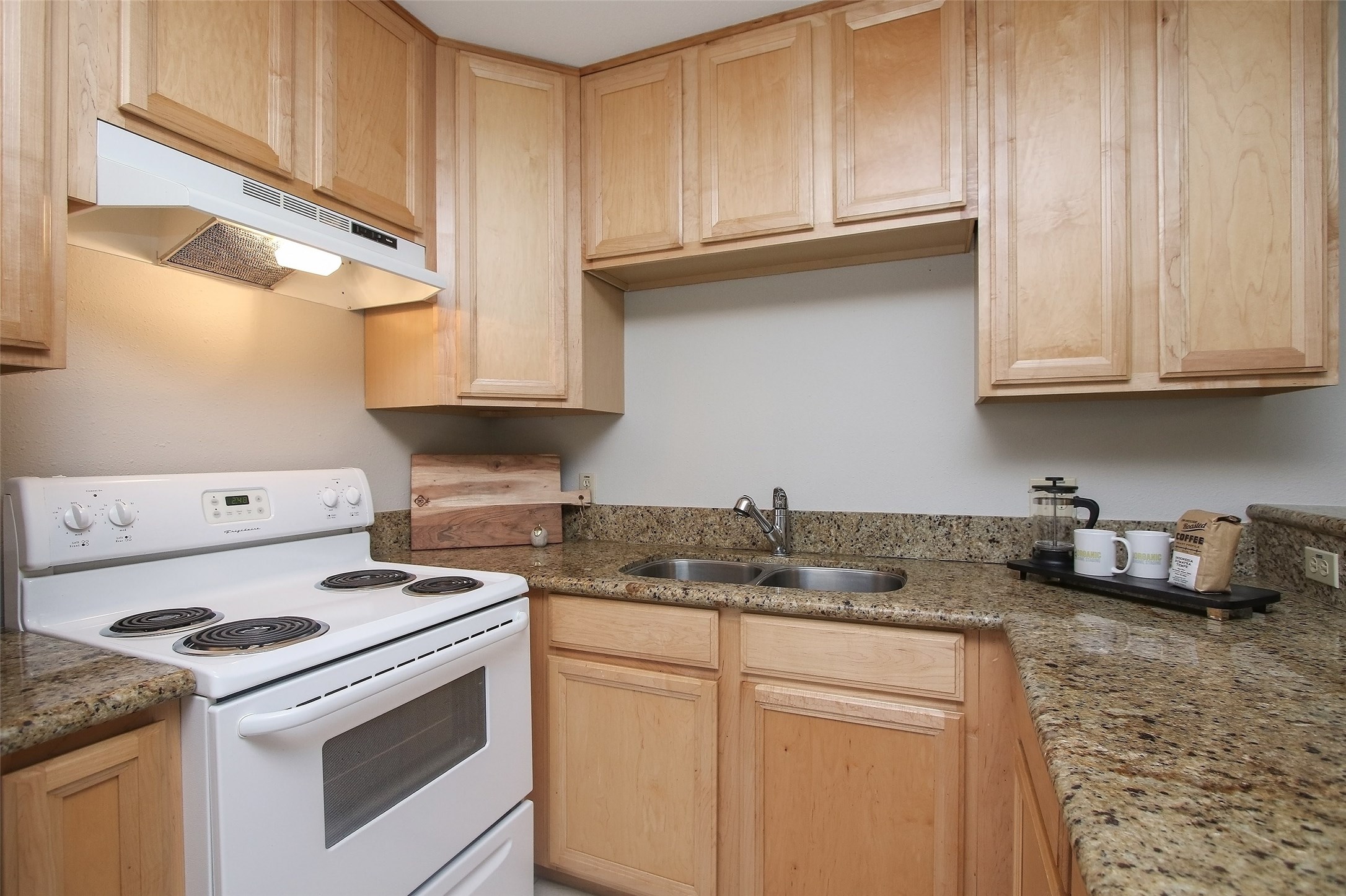 1307 Welch Street, Unit 6 Houston, TX 77006 - Photo 6 of 23 a kitchen with granite countertop cabinets and white appliances