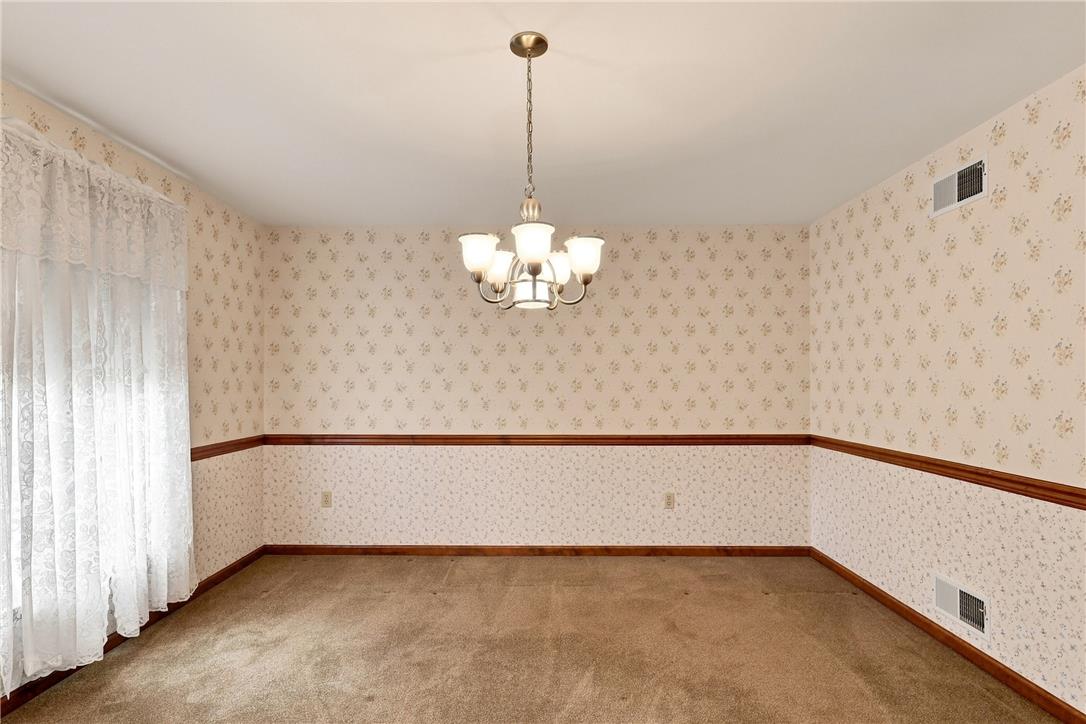 6090 Stone Post Road Bath, PA 18014 - Photo 21 of 57 A well-lit room featuring delicate floral wallpaper and a classic chandelier, offering a canvas for personalized design.