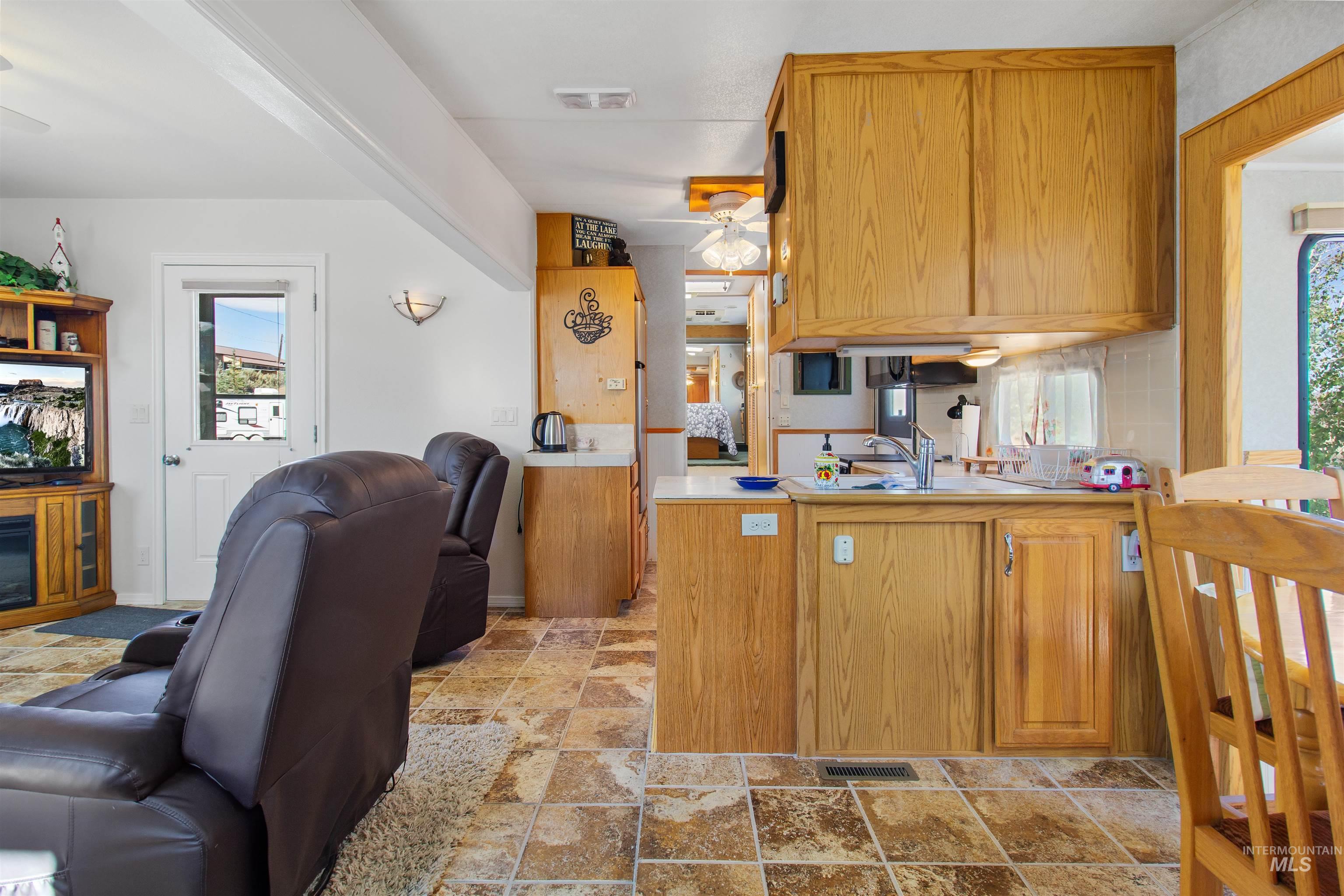 106 West Magic Road Shoshone, ID 83352 - Photo 13 of 45 Kitchen with wood-finish cabinetry, white countertops, and a stainless steel sink