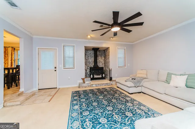 a living room with a couch and a chandelier
