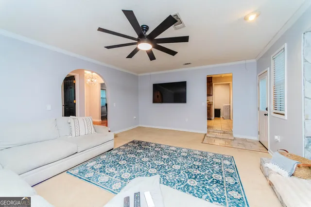 a living room with a flat screen tv and a rug