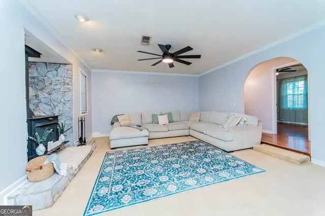 a living room with furniture and a fireplace