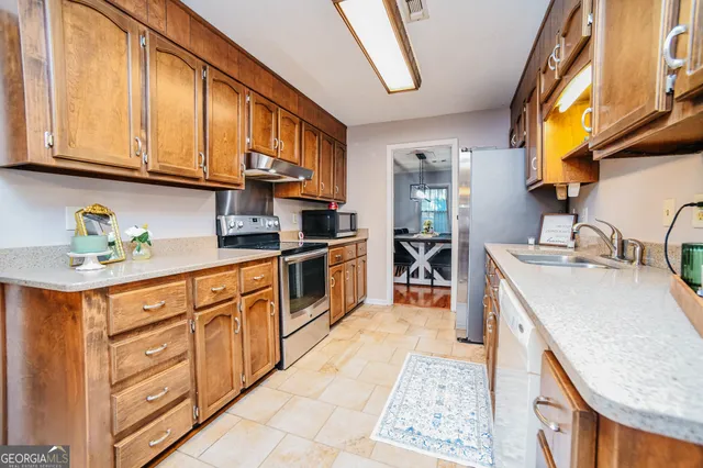 a kitchen with stainless steel appliances granite countertop a sink and cabinets