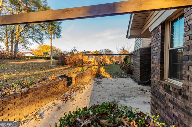 a view of a yard with wooden fence