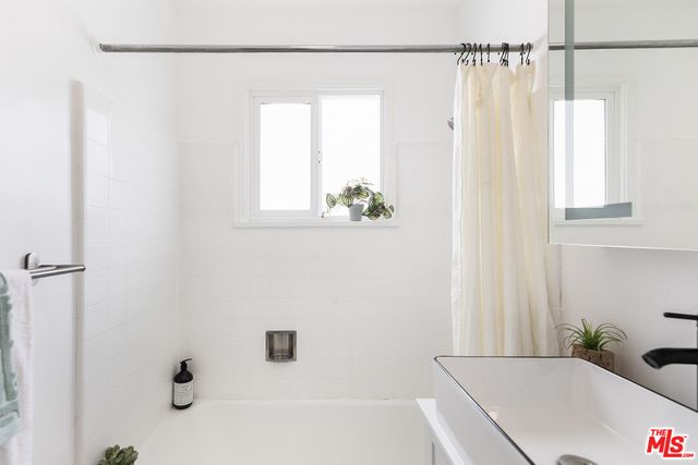 a bathroom with a tub and a shower curtain