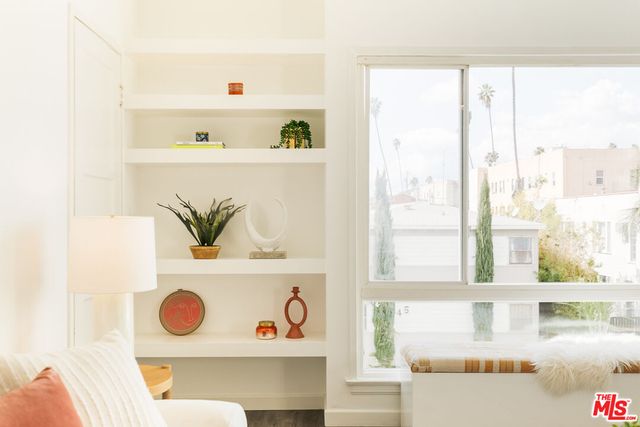 a view of a room with a fridge and rack on the wall