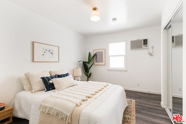 a bedroom with bed and window