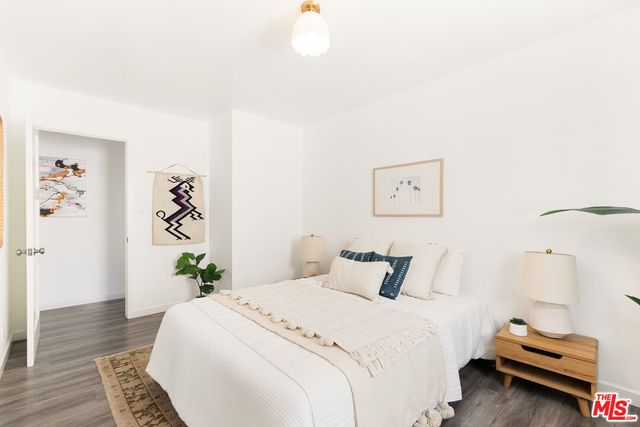 a bedroom with a bed and a potted plant