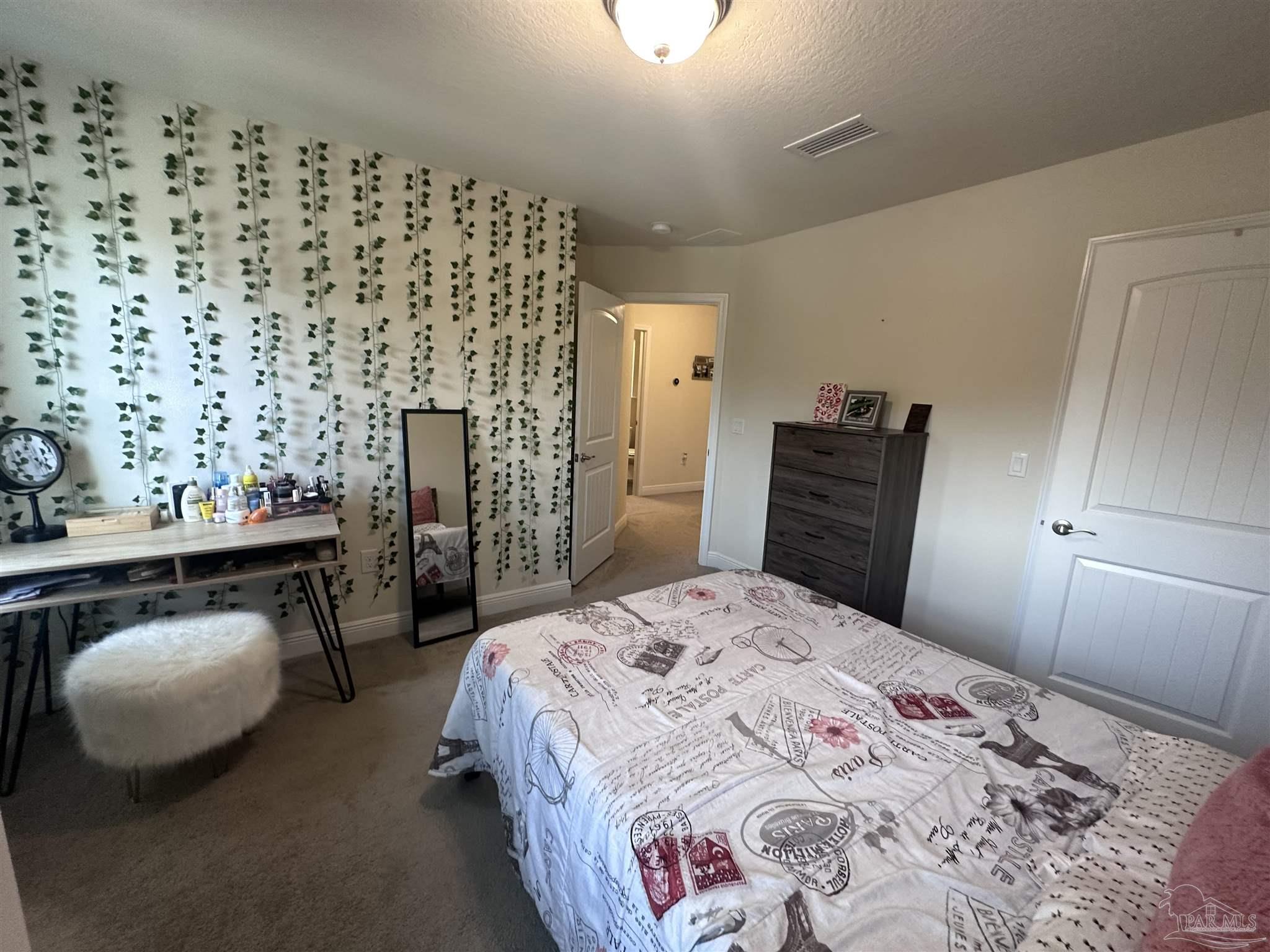 5217 Saufley Field Road Pensacola, FL 32526 - Photo 16 of 26 a bedroom with a bed and a couch
