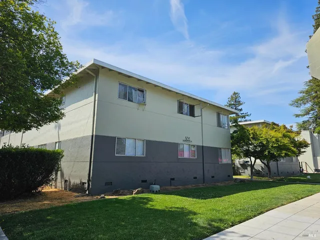 a backyard of a house with lots of green space and plants