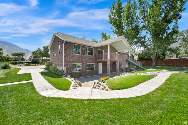 13658 South Fort Street Draper, UT 84020 - Photo 56 of 87 Expansive rear exterior featuring a two-story brick facade, a covered balcony, and a walk-out patio