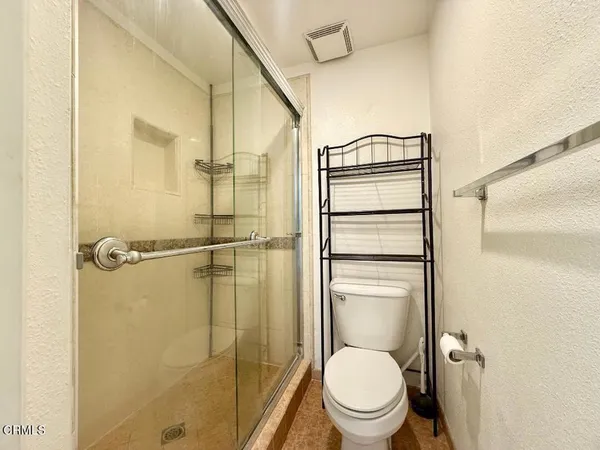 a bathroom with a toilet and a shower