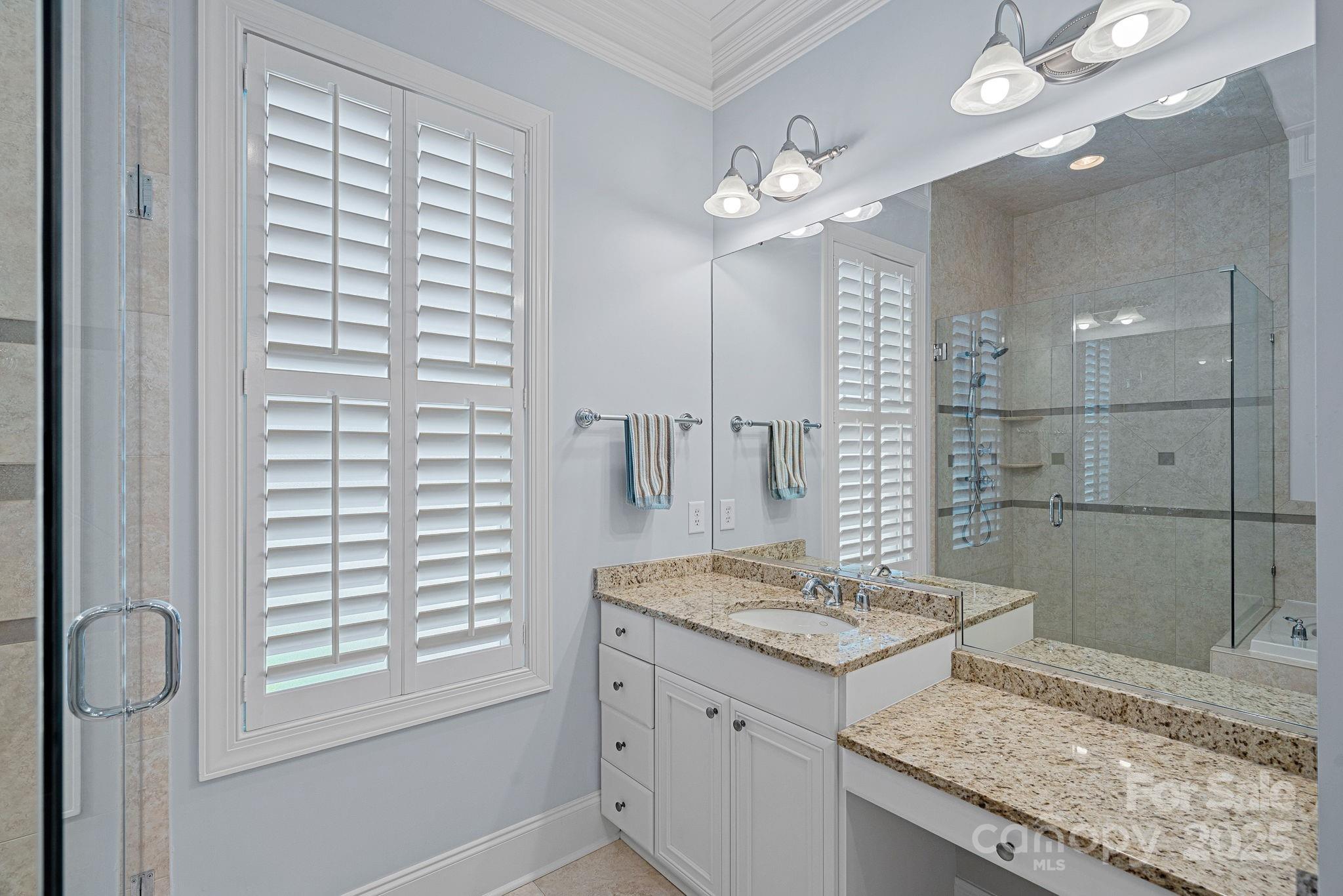 9803 Tree Canopy Road Charlotte, NC 28277 - Photo 14 of 42 a bathroom with a granite countertop sink a large mirror and shower