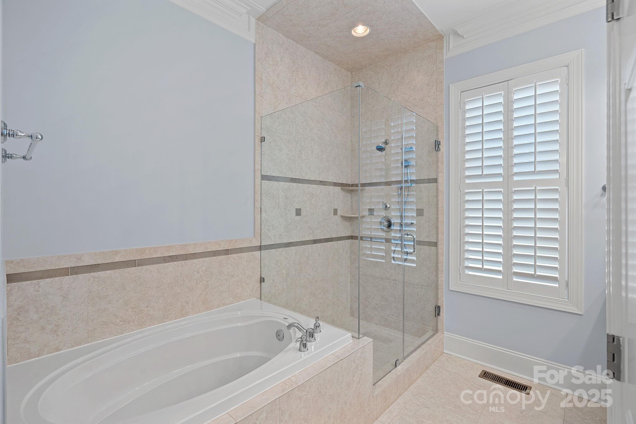 9803 Tree Canopy Road Charlotte, NC 28277 - Photo 15 of 42 a bathroom with a bathtub and a shower